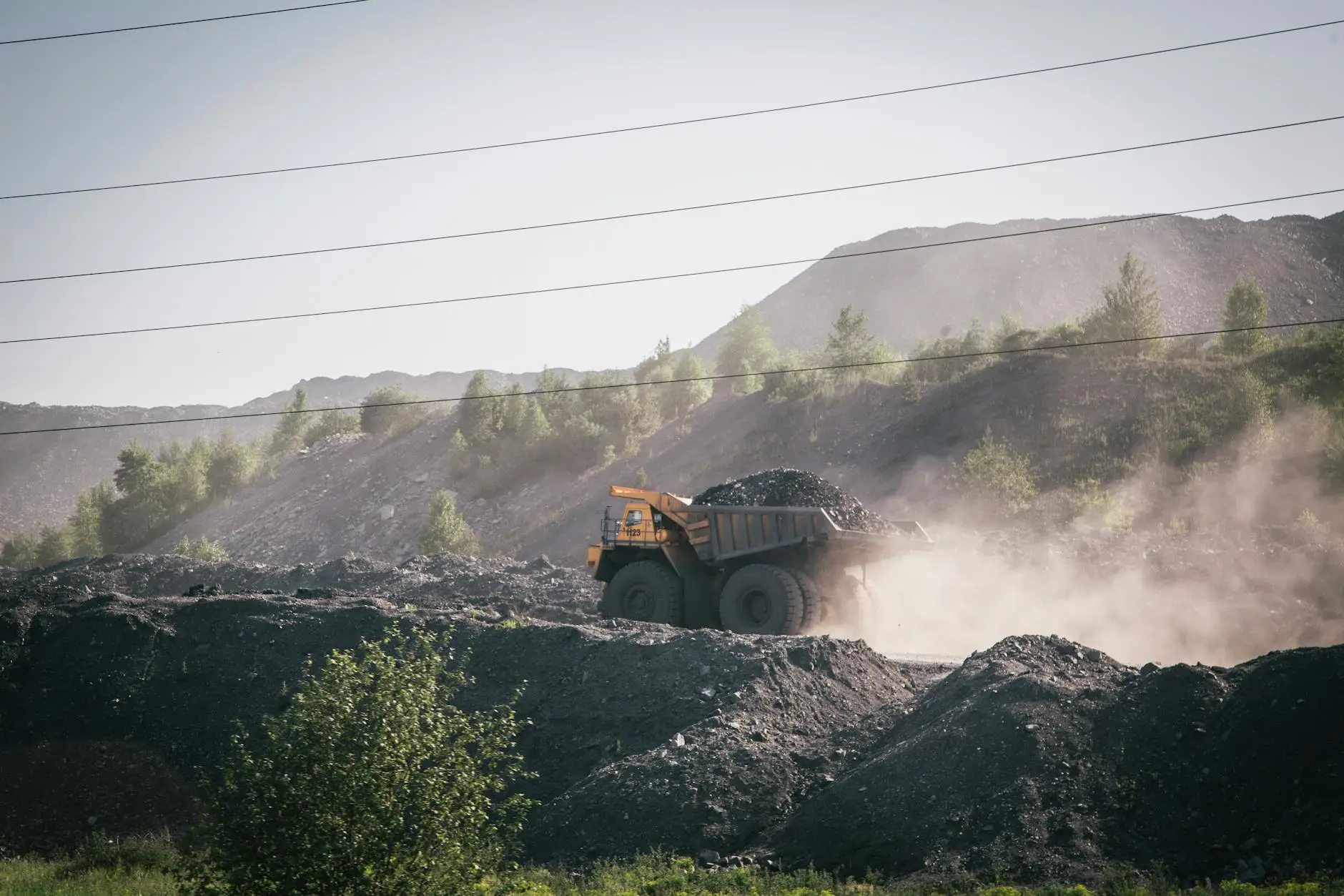 truck carrying stones on construction site in mountains
